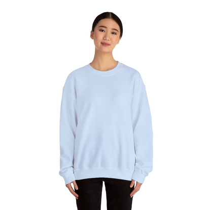 Woman wearing a light blue sweatshirt and black pants set against a white background
