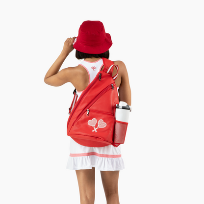 Person wearing a red backpack with a white design on a white background