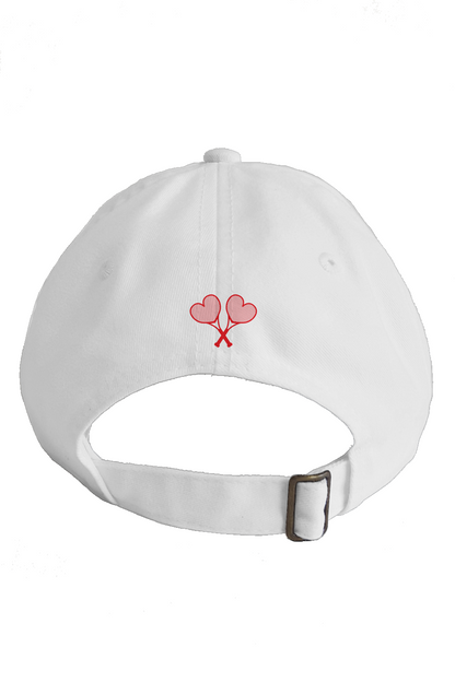 White cap with red heart and tennis racket design on a white background