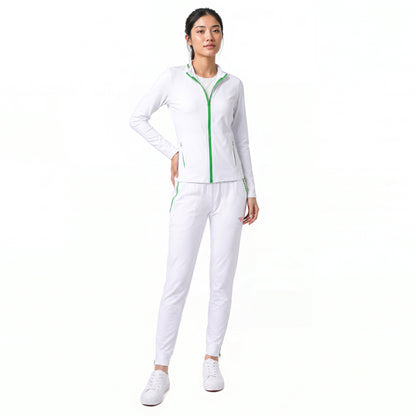A woman modeling a white athletic tracksuit with bright green zipper and piping details, paired with white sneakers, against a solid white background.