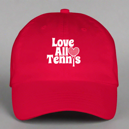 Red cap with 'Love All Tennis' text and heart design on a gray background