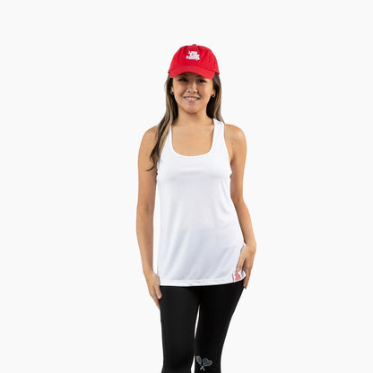 Woman wearing a white tank top, black leggings, and a red cap on a white background