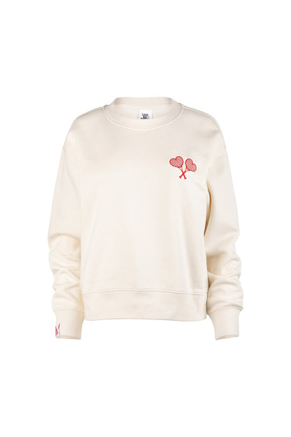 Cream-colored sweatshirt with a red heart design on a white background