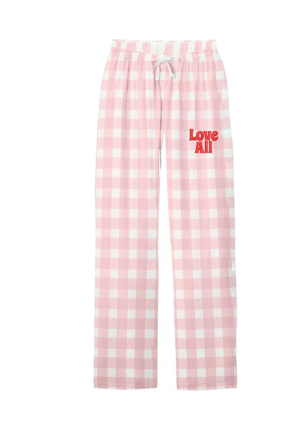 Pink and white plaid pajama pants with red "Love All" on the leg shown on a flat white background