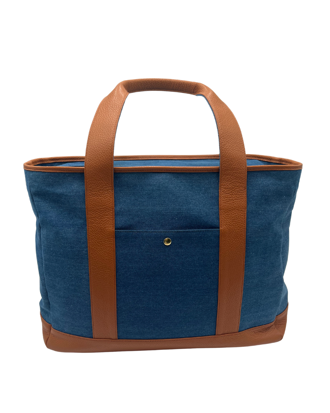 A blue denim tote bag with brown leather handles, trim, and base, shown against a plain white background.