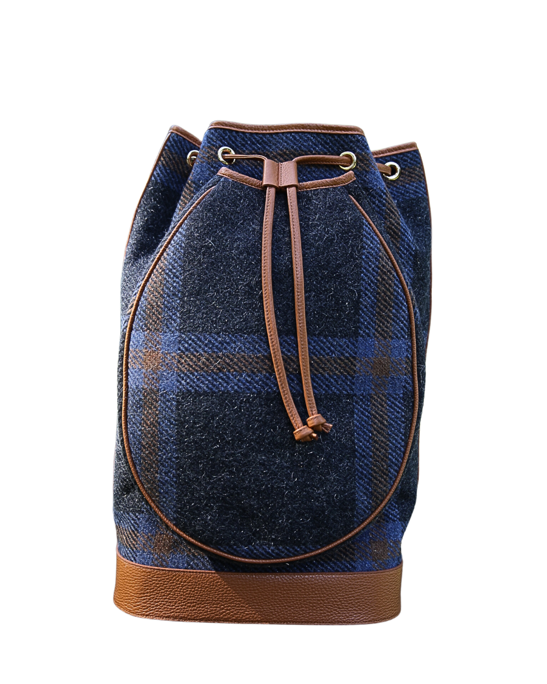 A blue and brown plaid wool bucket bag with tan leather trim, drawstring closure, and a textured leather base, shown against a plain white background.