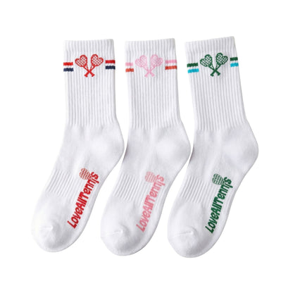 Three white socks with colorful designs and text on a white background